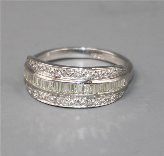 A modern 18ct white gold and three row channel set diamond ring, size X.